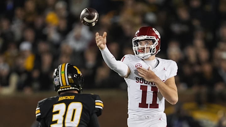 Nov 9, 2024; Columbia, Missouri, USA; Oklahoma Sooners wide receiver Jayden Gibson (1) throws a pass against Missouri Tigers linebacker Chuck Hicks (30) during the first half at Faurot Field at Memorial Stadium. Mandatory Credit: Jay Biggerstaff-Imagn Images