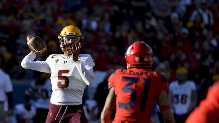Nov 24, 2018; Tucson, AZ, USA; Arizona State Sun Devils quarterback Manny Wilkins (5) passes the ball as Arizona Wildcats safety Tristan Cooper (31) defends during the second half of the Territorial Cup at Arizona Stadium. Mandatory Credit: Casey Sapio-Imagn Images