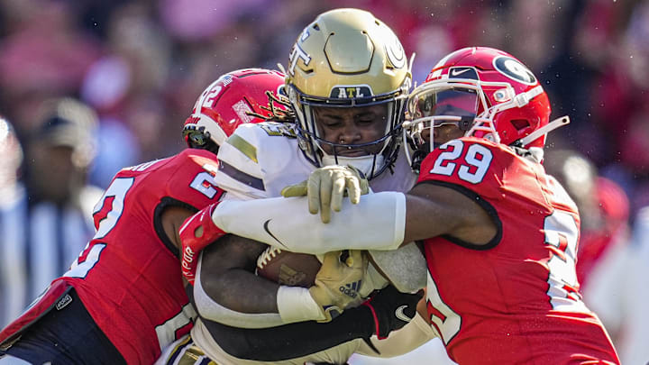 Nov 26, 2022; Athens, Georgia, USA; Georgia Tech Yellow Jackets running back Jamie Felix (23) is tackled by Georgia Bulldogs linebacker Smael Mondon Jr. (2) and defensive back Christopher Smith (29) during the first half at Sanford Stadium. Mandatory Credit: Dale Zanine-Imagn Images