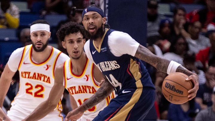 Nov 3, 2024; New Orleans, Louisiana, USA;  New Orleans Pelicans forward Brandon Ingram (14) dribbles against Atlanta Hawks forward Zaccharie Risacher (10) during the first half at Smoothie King Center. Mandatory Credit: Stephen Lew-Imagn Images