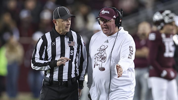 Nov 30, 2024; College Station, Texas, USA; Texas A&M Aggies head coach Mike Elko talks with an official during the second quarter against the Texas Longhorns at Kyle Field. Mandatory Credit: Troy Taormina-Imagn Images