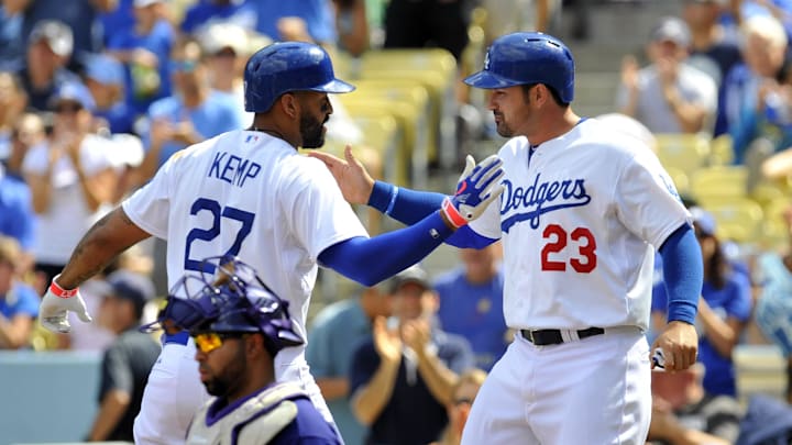 Los Angeles Dodgers left fielder Matt Kemp (27) and first baseman Adrian Gonzalez (23) celebrate after scoring runs in the first inning against the Colorado Rockies at Dodger Stadium. 