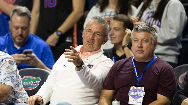 Former Florida football coach Urban Meyer, left, enjoys the first half of an NCAA basketball game at Steven C. O'Connell Center Exactech arena in Gainesville, FL on Tuesday, January 6, 2026. [Alan Youngblood/Gainesville Sun]