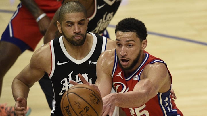 Mar 27, 2021; Los Angeles, California, USA; Philadelphia 76ers guard Ben Simmons (25) passes the ball in front of LA Clippers forward Nicolas Batum (33) during the second half at Staples Center. Mandatory Credit: Kelvin Kuo-Imagn Images