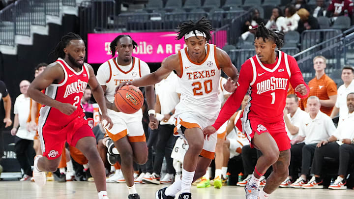 Nov 4, 2024; Las Vegas, Nevada, USA; Texas Longhorns guard Tre Johnson (20) dribbles against Ohio State Buckeyes guard Meechie Johnson Jr. (1) during the first half at T-Mobile Arena. Mandatory Credit: Stephen R. Sylvanie-Imagn Images