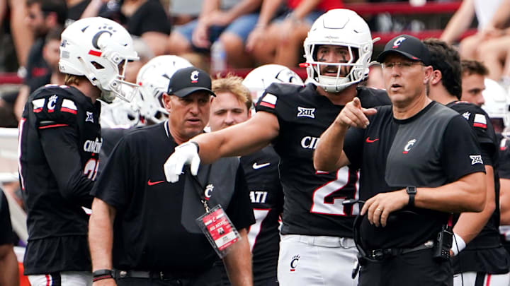 Cincinnati Bearcats head coach Scott Satterfield speaks with players during a NCAA men’s college football game between the Cincinnati Bearcats and Northwestern State Demons, Saturday, Sept. 13, 2025, at Nippert Stadium in Cincinnati. Cincinnati Bearcats head coach Scott Satterfield speaks with players during a NCAA men’s college football game between the Cincinnati Bearcats and Northwestern State Demons, Saturday, Sept. 13, 2025, at Nippert Stadium in Cincinnati.