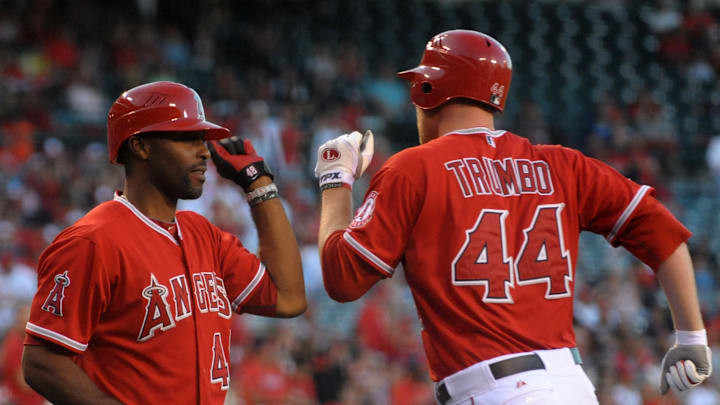 Jun 5, 2012; Anaheim, CA, USA; Los Angeles Angels third baseman Mark Trumbo (44) is greeted by right fielder Torii Hunter (48) after hitting a solo home run in the second inning against the Seattle Mariners at Angel Stadium. 