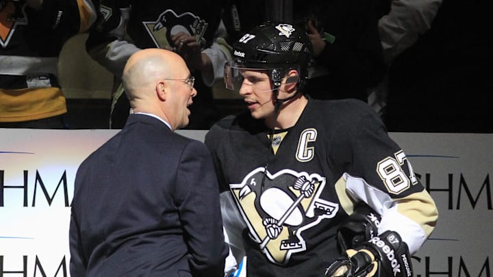 Feb 11, 2015; Pittsburgh, PA, USA; NBC network hockey analyst Pierre McGuire (left) shakes hand with Pittsburgh Penguins center Sidney Crosby (87) after the Penguins defeated the Detroit Red Wings at the CONSOL Energy Center. The Penguins won 4-1. Mandatory Credit: Charles LeClaire-Imagn Images