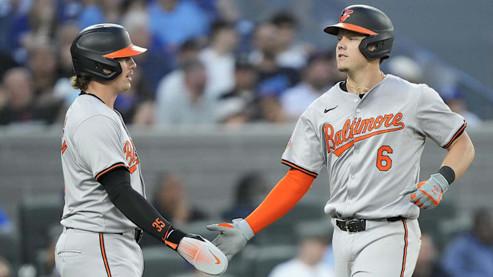  Jun 4, 2024; Toronto, Ontario, CAN; Baltimore Orioles designated hitter Adley Rutschman (35) congratulates first baseman Ryan Mountcastle (6) after his two run home run against the Toronto Blue Jays during the fifth inning at Rogers Centre. Mandatory Credit: John E. Sokolowski-USA TODAY Sports