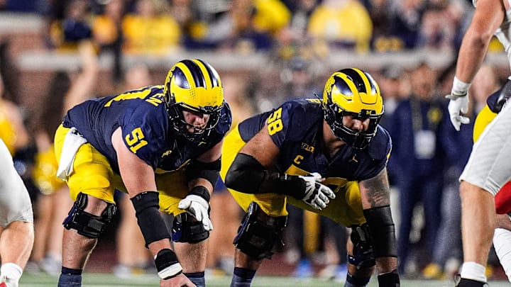 Michigan offensive lineman Greg Crippen (51), center, and offensive lineman Giovanni El-Hadi (58) get ready for a snap against New Mexico during the second half at Michigan Stadium in Ann Arbor on Saturday, August 30, 2025.