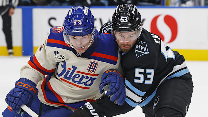 Oct 28, 2025; Edmonton, Alberta, CAN; Edmonton Oilers /forward Ryan Nugent-Hopkins (93) and Utah Mammoth forward Michael Carcone (53) battles for position during the third period at Rogers Place. Mandatory Credit: Perry Nelson-Imagn Images