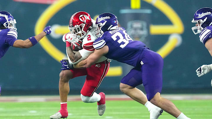 Dec 23, 2023; Las Vagas, NV, USA; Utah Utes running back Micah Bernard (2) is tackled by Northwestern Wildcats linebacker Xander Mueller (34) during the first quarter at Allegiant Stadium. Mandatory Credit: Stephen R. Sylvanie-Imagn Images