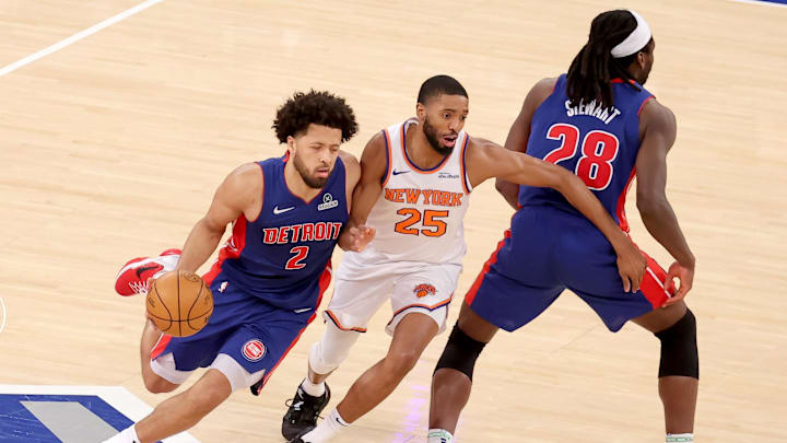 Jan 13, 2025; New York, New York, USA; Detroit Pistons center Isaiah Stewart (28) sets a pick for guard Cade Cunningham (2) as he drives around New York Knicks forward Mikal Bridges (25) during the fourth quarter at Madison Square Garden. Mandatory Credit: Brad Penner-Imagn Images
