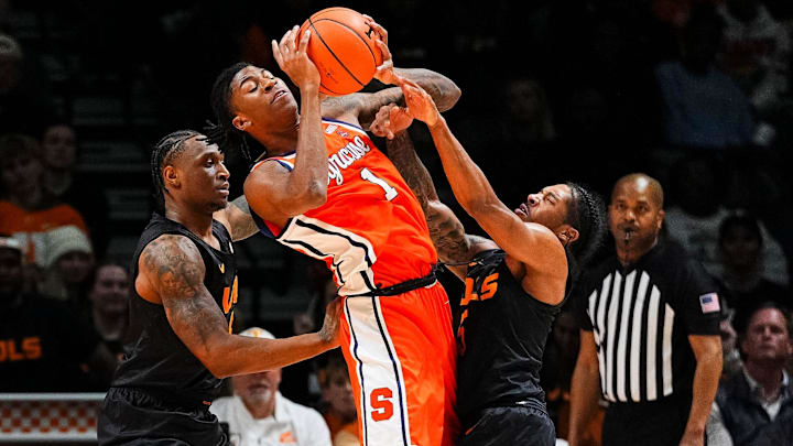 Tennessee guard Darlinstone Dubar (8) and Tennessee guard Zakai Zeigler (5) defend Syracuse forward Donnie Freeman (1) during a college basketball game between Tennessee and Syracuse held at Thompson-Boling Arena at Food City Center in Knoxville, Tenn., on Tuesday, Dec. 3, 2024.