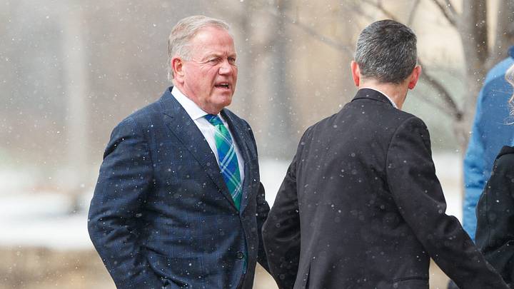 Brian Kelly, left, arrives at the funeral service for former Notre Dame football head coach Lou Holtz at the Basilica of the Sacred Heart at the University of Notre Dame on Monday, March 16, 2026, in South Bend. Holtz died on March 4, 2026. Brian Kelly, left, arrives at the funeral service for former Notre Dame football head coach Lou Holtz at the Basilica of the Sacred Heart at the University of Notre Dame on Monday, March 16, 2026, in South Bend. Holtz died on March 4, 2026.