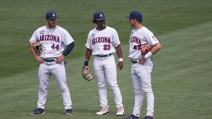 Jun 21, 2021; Omaha, Nebraska, USA;  Arizona Wildcats outfielder Tanner O'Tremba (44) and outfielder Donta Williams (23) and outfielder Ryan Holgate (42) during a break in the seventh inning against the Stanford Cardinal at TD Ameritrade Park. Mandatory Credit: Steven Branscombe-Imagn Images