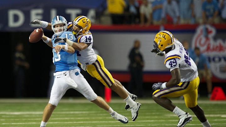 September 4, 2010; Atlanta, GA, USA; North Carolina Tar Heels quarterback T.J. Yates (13) is sacked by LSU Tigers defensive back Tyrann Mathieu (14) in the fourth quarter at the Georgia Dome. LSU defeated North Carolina 30-24. 