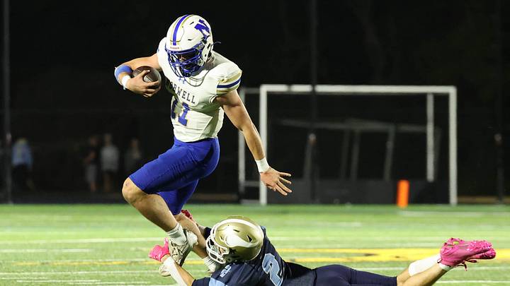Norwell High School quarterback Jack Luccarelli is tackled by East Bridgewater Jr/Sr High School's Mark Lee during their game on Friday, Oct. 3, 2025. Norwell High School quarterback Jack Luccarelli is tackled by East Bridgewater Jr/Sr High School's Mark Lee during their game on Friday, Oct. 3, 2025.