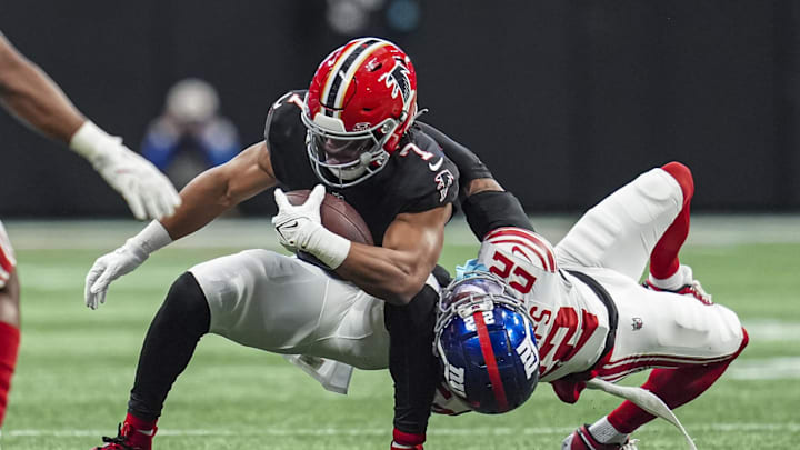 Dec 22, 2024; Atlanta, Georgia, USA; Atlanta Falcons running back Bijan Robinson (7) is tackled by New York Giants cornerback Dru Phillips (22) at Mercedes-Benz Stadium. Mandatory Credit: Dale Zanine-Imagn Images