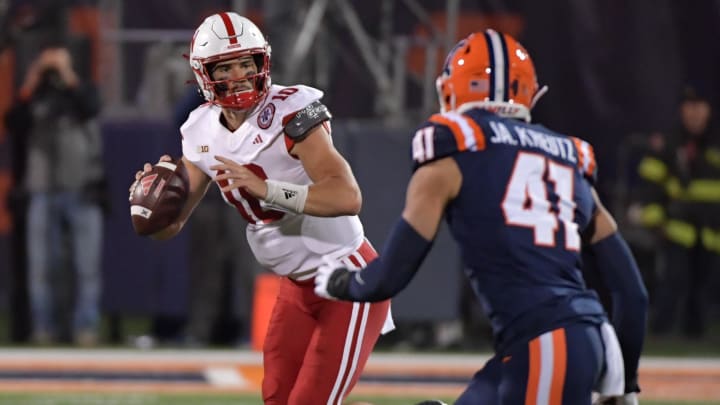 Oct 6, 2023; Champaign, Illinois, USA; Nebraska Cornhuskers quarterback Heinrich Haarberg (10) is pursued by Illinois Fighting Illini linebacker James Kreutz (41) during the first half at Memorial Stadium. Mandatory Credit: Ron Johnson-USA TODAY Sports Oct 6, 2023; Champaign, Illinois, USA; Nebraska Cornhuskers quarterback Heinrich Haarberg (10) is pursued by Illinois Fighting Illini linebacker James Kreutz (41) during the first half at Memorial Stadium. Mandatory Credit: Ron Johnson-USA TODAY Sports