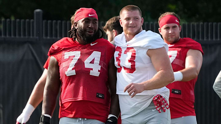 Aug 1, 2024; Columbus, OH, USA; Ohio State Buckeyes offensive lineman Donovan Jackson (74) and defensive end Jack Sawyer (33) stretch during football camp at the Woody Hayes Athletic Complex.