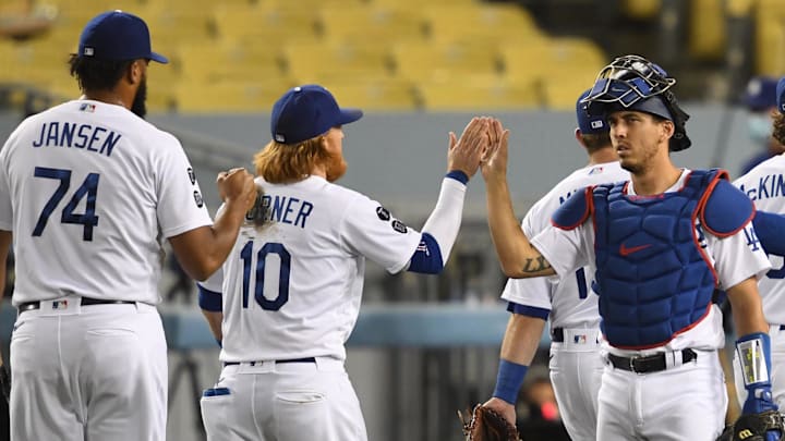 Los Angeles Dodgers relief pitcher Kenley Jansen (74), third baseman Justin Turner (10) and catcher Austin Barnes (15) high five after defeating the Colorado Rockies in the ninth inning at Dodger Stadium in 2021. Los Angeles Dodgers relief pitcher Kenley Jansen (74), third baseman Justin Turner (10) and catcher Austin Barnes (15) high five after defeating the Colorado Rockies in the ninth inning at Dodger Stadium in 2021.