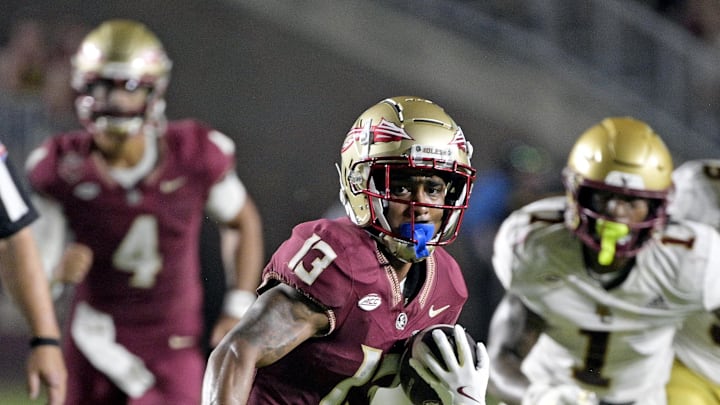 Sep 2, 2024; Tallahassee, Florida, USA; Florida State Seminoles running back Jaylin Lucas (13) runs the ball during the first half against the Boston College Eagles at Doak S. Campbell Stadium. Mandatory Credit: Melina Myers-Imagn Images