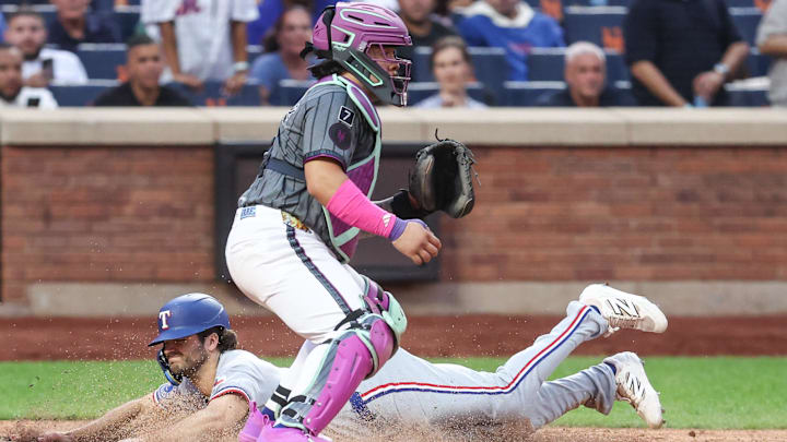 Sep 13, 2025; New York City, New York, USA;  Texas Rangers shortstop Josh Smith (8) slides past New York Mets catcher Francisco Alvarez (4) in the eighth inning against the New York Mets at Citi Field. Mandatory Credit: Wendell Cruz-Imagn Images