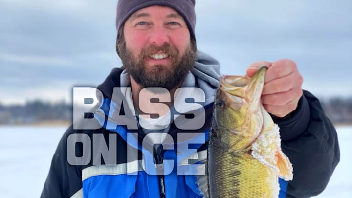 The author shows off a chunky largemouth bass caught through the ice using downsized lures.