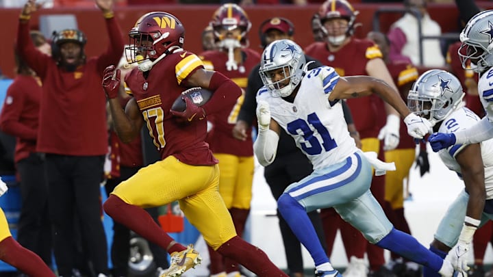 Nov 24, 2024; Landover, Maryland, USA; Washington Commanders wide receiver Terry McLaurin (17) runs with the ball en route to a touchdown as Dallas Cowboys cornerback Josh Butler (31) chases during the fourth quarter at Northwest Stadium. Mandatory Credit: Geoff Burke-Imagn Images Nov 24, 2024; Landover, Maryland, USA; Washington Commanders wide receiver Terry McLaurin (17) runs with the ball en route to a touchdown as Dallas Cowboys cornerback Josh Butler (31) chases during the fourth quarter at Northwest Stadium. Mandatory Credit: Geoff Burke-Imagn Images