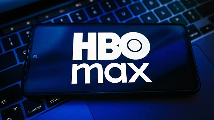 POLAND - 2026/06/08: In this photo illustration, the HBO MAX logo is seen displayed on a smartphone on the top of a laptop. 