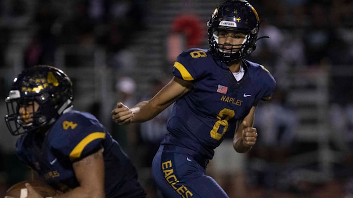 Nov 14, 2019; Naples, FL, USA; Naples High School's Dominiq Ponder hands the ball off, during their 6A regional semifinal game against Miami Central, Friday, Nov. 15, 2019, at Staver Field in Naples. Mandatory Credit: Jon Austria/Naples Daily via USA TODAY NETWORK Nov 14, 2019; Naples, FL, USA; Naples High School's Dominiq Ponder hands the ball off, during their 6A regional semifinal game against Miami Central, Friday, Nov. 15, 2019, at Staver Field in Naples. Mandatory Credit: Jon Austria/Naples Daily via USA TODAY NETWORK