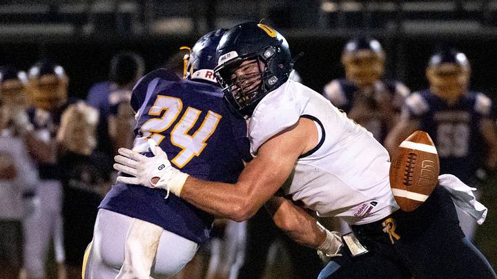 Regina’s Tate Wallace (0) tackles Alburnett’s Laken Caves (24) as the ball is passed toward them during a high school football game Sept. 10, 2026 in Alburnett, Iowa.