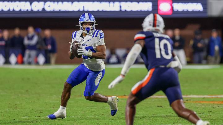 Oct 23, 2026; Charlottesville, Virginia, USA; Duke Blue Devils running back Nate Sheppard (20) throws the game-winning touchdown pass against the Virginia Cavaliers during the second half at Scott Stadium. Oct 23, 2026; Charlottesville, Virginia, USA; Duke Blue Devils running back Nate Sheppard (20) throws the game-winning touchdown pass against the Virginia Cavaliers during the second half at Scott Stadium.