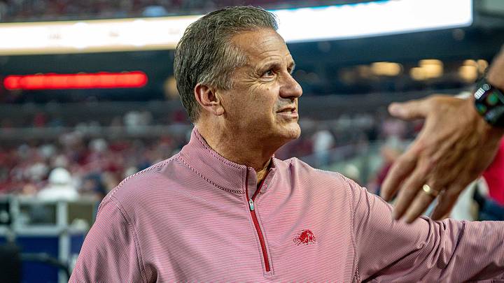 Arkansas Razorbacks men's basketball coach John Calipari shakes hands with fans before the football game against Tulsa.