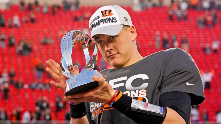 Jan 30, 2022; Kansas City, Missouri, USA; Cincinnati Bengals quarterback Joe Burrow (9) holds the Lamar Hunt trophy after winning the AFC Championship Game against the Kansas City Chiefs at GEHA Field at Arrowhead Stadium. The Cincinnati Bengals won 27-24. Mandatory Credit: Jay Biggerstaff-USA TODAY Sports Jan 30, 2022; Kansas City, Missouri, USA; Cincinnati Bengals quarterback Joe Burrow (9) holds the Lamar Hunt trophy after winning the AFC Championship Game against the Kansas City Chiefs at GEHA Field at Arrowhead Stadium. The Cincinnati Bengals won 27-24. Mandatory Credit: Jay Biggerstaff-USA TODAY Sports