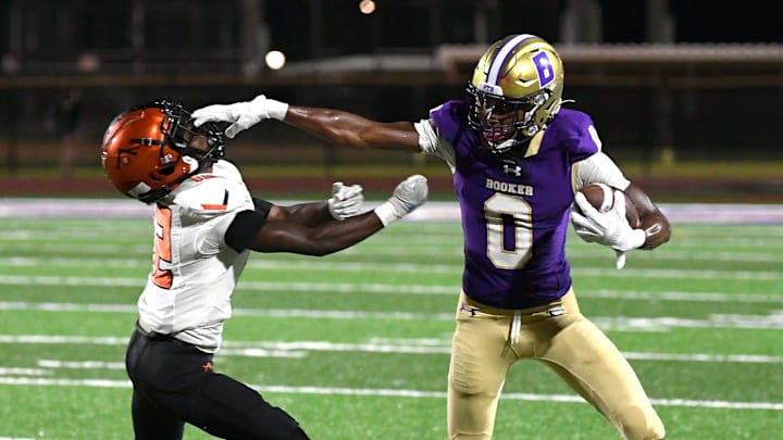 Booker's defensive back/wide receiver Chauncey Kennon (#0) puts the stiff arm to Lely's wide receiver, Dwayne Liberal (#12). The Booker Tornadoes hosted the Lely Trojans (Naples, FL) Friday night, Aug. 23, 2024, who lost to Booker 46-0 during the first regular non-conference season game of the year.