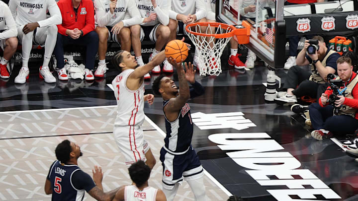 Mar 15, 2025; Kansas City, MO, USA; Arizona Wildcats guard Caleb Love (1) shoots the ball over Houston Cougars guard Milos Uzan (7) during the second half for the Big 12 Conference Tournament Championship game at T-Mobile Center. Mandatory Credit: William Purnell-Imagn Images