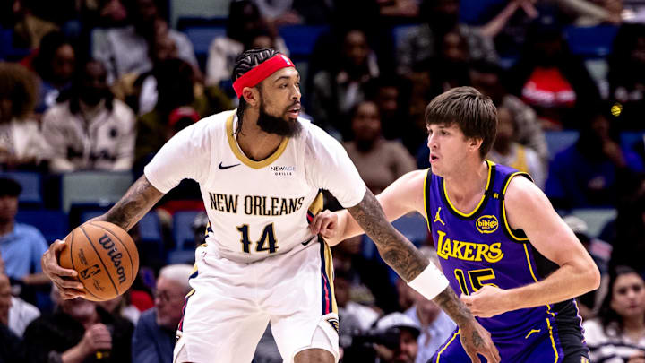 Nov 16, 2024; New Orleans, Louisiana, USA;  New Orleans Pelicans forward Brandon Ingram (14) dribbles against Los Angeles Lakers guard Austin Reaves (15) during the first half at Smoothie King Center. Mandatory Credit: Stephen Lew-Imagn Images