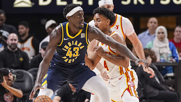 Oct 8, 2024; Atlanta, Georgia, USA; Indiana Pacers forward Pascal Siakam (43) tries to move the ball against Atlanta Hawks guard Kobe Bufkin (4) during the first half at State Farm Arena. Mandatory Credit: Dale Zanine-Imagn Images