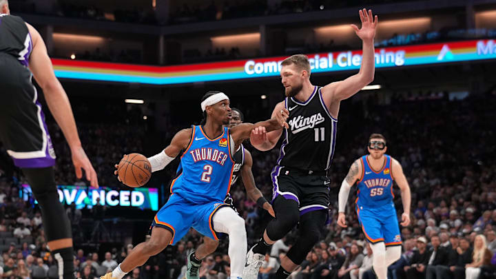 Mar 25, 2025; Sacramento, California, USA; Oklahoma City Thunder guard Shai Gilgeous-Alexander (2) dribbles the ball next to Sacramento Kings center Domantas Sabonis (11) in the third quarter at the Golden 1 Center. Mandatory Credit: Cary Edmondson-Imagn Images Mar 25, 2025; Sacramento, California, USA; Oklahoma City Thunder guard Shai Gilgeous-Alexander (2) dribbles the ball next to Sacramento Kings center Domantas Sabonis (11) in the third quarter at the Golden 1 Center. Mandatory Credit: Cary Edmondson-Imagn Images