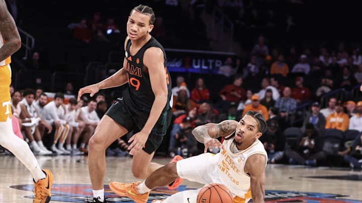 Dec 10, 2024; New York, New York, USA;  Miami Hurricanes guard Divine Ugochukwu (99) collides with Tennessee Volunteers guard Zakai Zeigler (5) in the first half at Madison Square Garden. Mandatory Credit: Wendell Cruz-Imagn Images