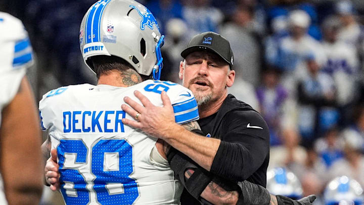 Detroit Lions head coach Dan Campbell hugs offensive tackle Taylor Decker (68) during warmup before the Dallas Cowboys game at Ford Field in Detroit on Thursday, Dec. 4, 2025.