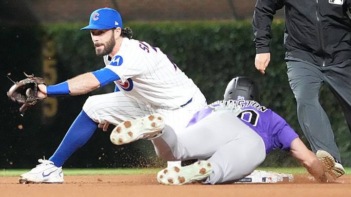 Jun 16, 2026; Chicago, Illinois, USA; Chicago Cubs shortstop Dansby Swanson (7) tags out Colorado Rockies right fielder Troy Johnston (20) on a steal attempt of second base during the eighth inning at Wrigley Field. Mandatory Credit: David Banks-Imagn Images