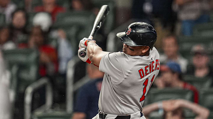 Former Boston Red Sox designated hitter Rafael Devers (11) drives in two runs with a single against the Atlanta Braves during the ninth inning at Truist Park.