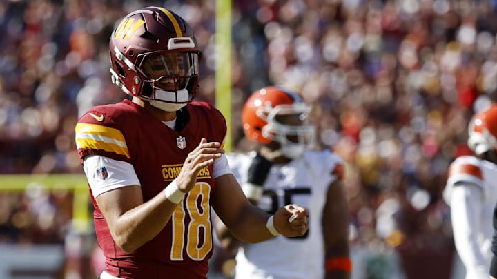 Oct 6, 2024; Landover, Maryland, USA; Washington Commanders quarterback Marcus Mariota (18) smiles while jogging onto the field against the Cleveland Browns during the fourth quarter at NorthWest Stadium. Mandatory Credit: Geoff Burke-Imagn Images