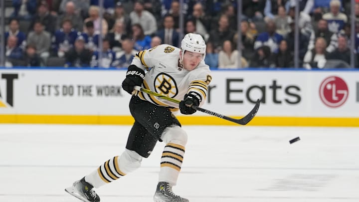Apr 24, 2024; Toronto, Ontario, CAN; Boston Bruins defenseman Mason Lohrei (6) shoots the puck against the Toronto Maple Leafs in game three of the first round of the 2024 Stanley Cup Playoffs at Scotiabank Arena. Mandatory Credit: John E. Sokolowski-Imagn Images