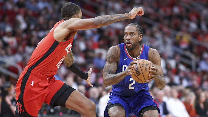 Mar 6, 2024; Houston, Texas, USA; Los Angeles Clippers forward Kawhi Leonard (2) controls the ball as Houston Rockets forward Jabari Smith Jr. (10) defends during the game at Toyota Center. Mandatory Credit: Troy Taormina-Imagn Images