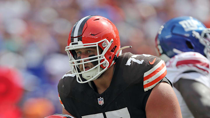 Cleveland Browns guard Wyatt Teller (77) helps up quarterback Deshaun Watson (4) during the first half of an NFL football game against the New York Giants at Huntington Bank Field, Sunday, Sept. 22, 2024, in Cleveland, Ohio.