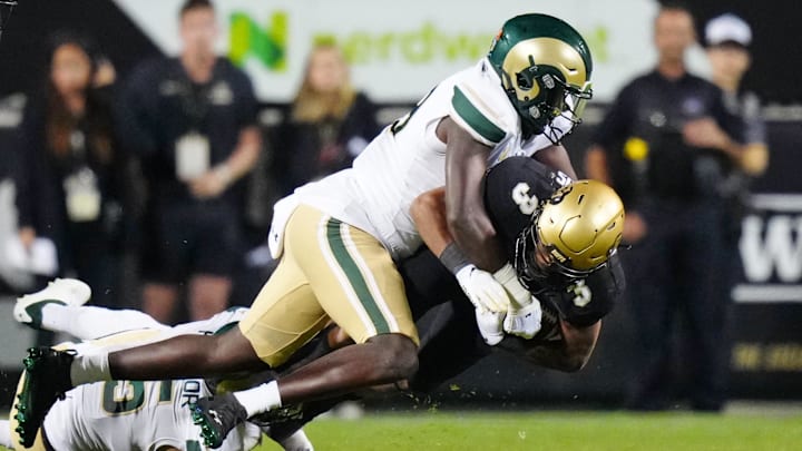 Colorado State Rams linebacker Buom Jock tackles Colorado Buffaloes running back Dylan Edwards Colorado State Rams linebacker Buom Jock tackles Colorado Buffaloes running back Dylan Edwards